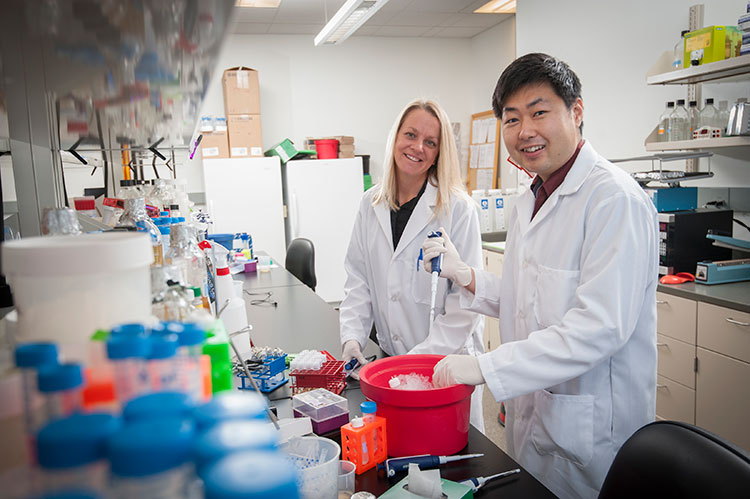 Dr. Kasinski in her lab with her previous PhD student, Dr. Sander Myoung.