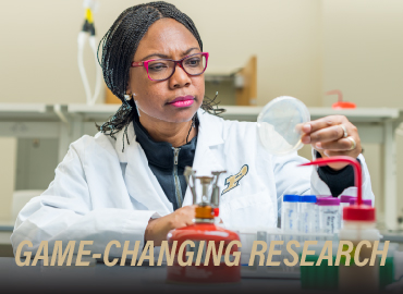 scientist looking at petri dish with text overlayed "Game-changing research"