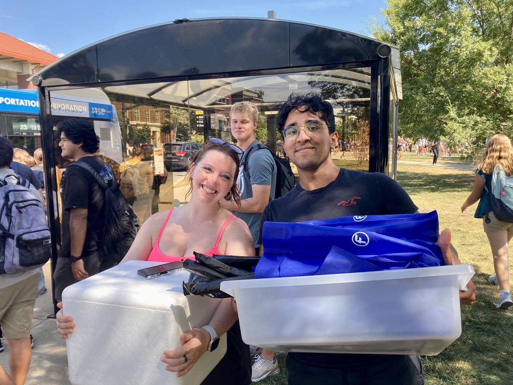 teaching team members holding containers