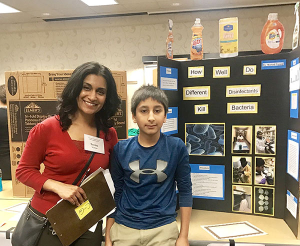 Seema with student at science fair