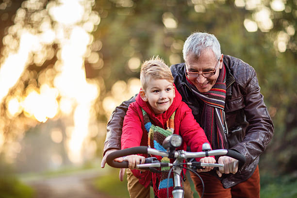 Man helping child ride a bike