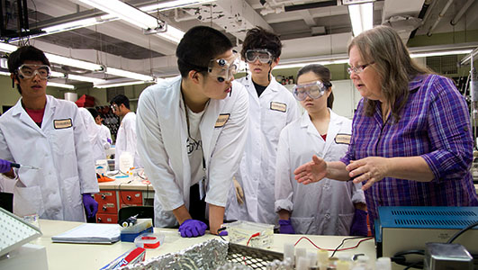 Purdue University ecology and evolutionary biology professor Susan Karcher, far right, answers student questions during a laboratory activity at Lilly Hall in connection with the 2013 USA Biology Olympiad National Finals, sponsored by the Center for Excellence in Education.