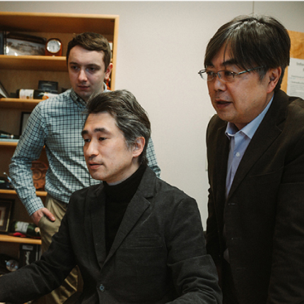 Mercy Anawe sitting at a table with her award