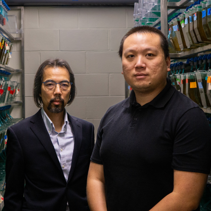 Yuk Fai Leung and BC Wang stand in their lab