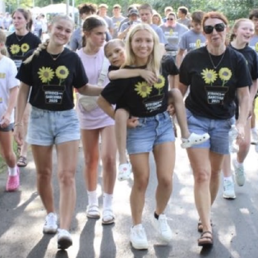 Gabriella Conjelko giving her cousin Maia a piggyback ride and walking with others