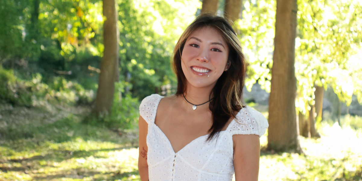 Photo of Alex Xiao standing in a wooded area