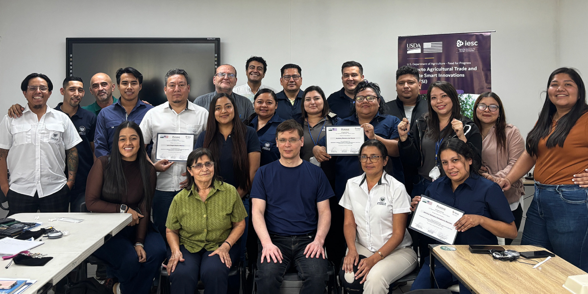 Students and instructors of a training session gather for a group photo