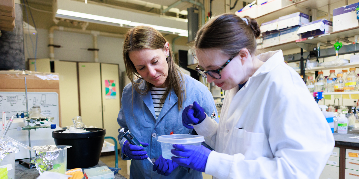 Angeline Lyon works with a student in her lab