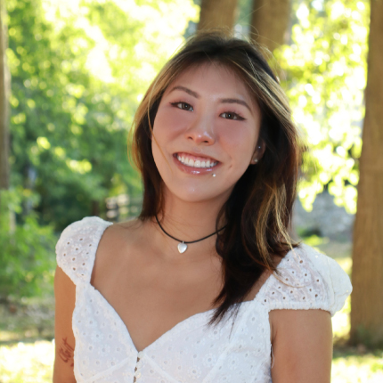 Photo of Alex Xiao standing in a wooded area