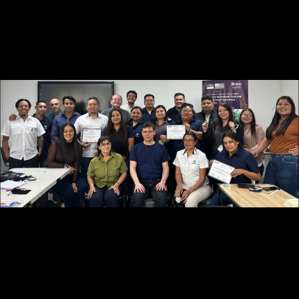 Students and instructors of a training session gather for a group photo