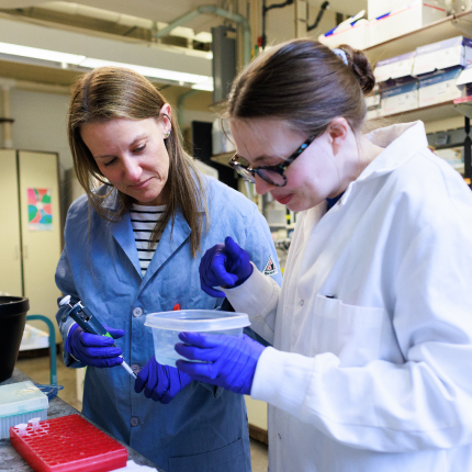 Angeline Lyon works with a student in her lab